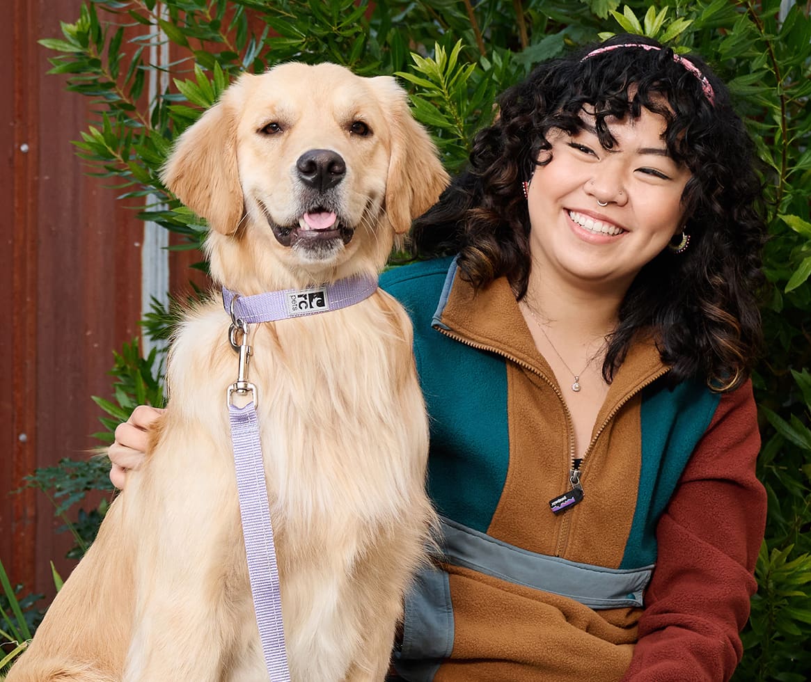 Woman sitting with golden retriever